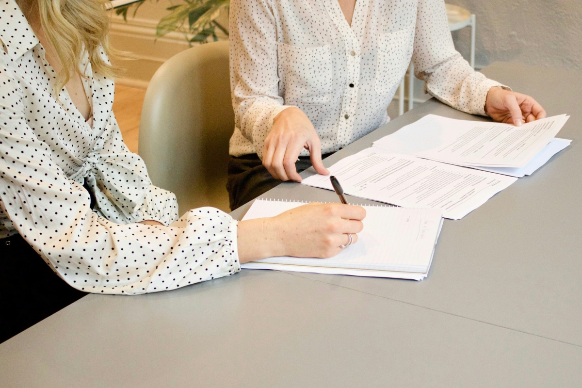 Two people reviewing papers