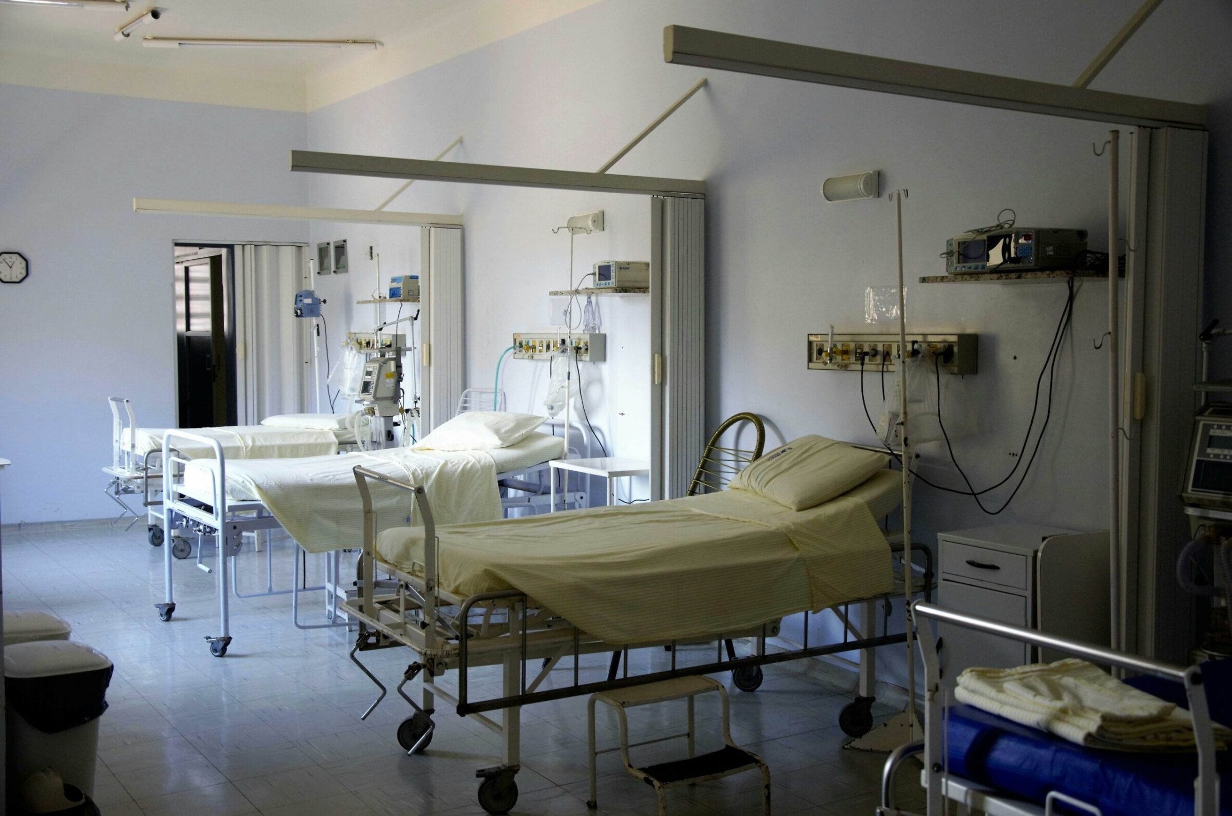 A hospital room with three beds
