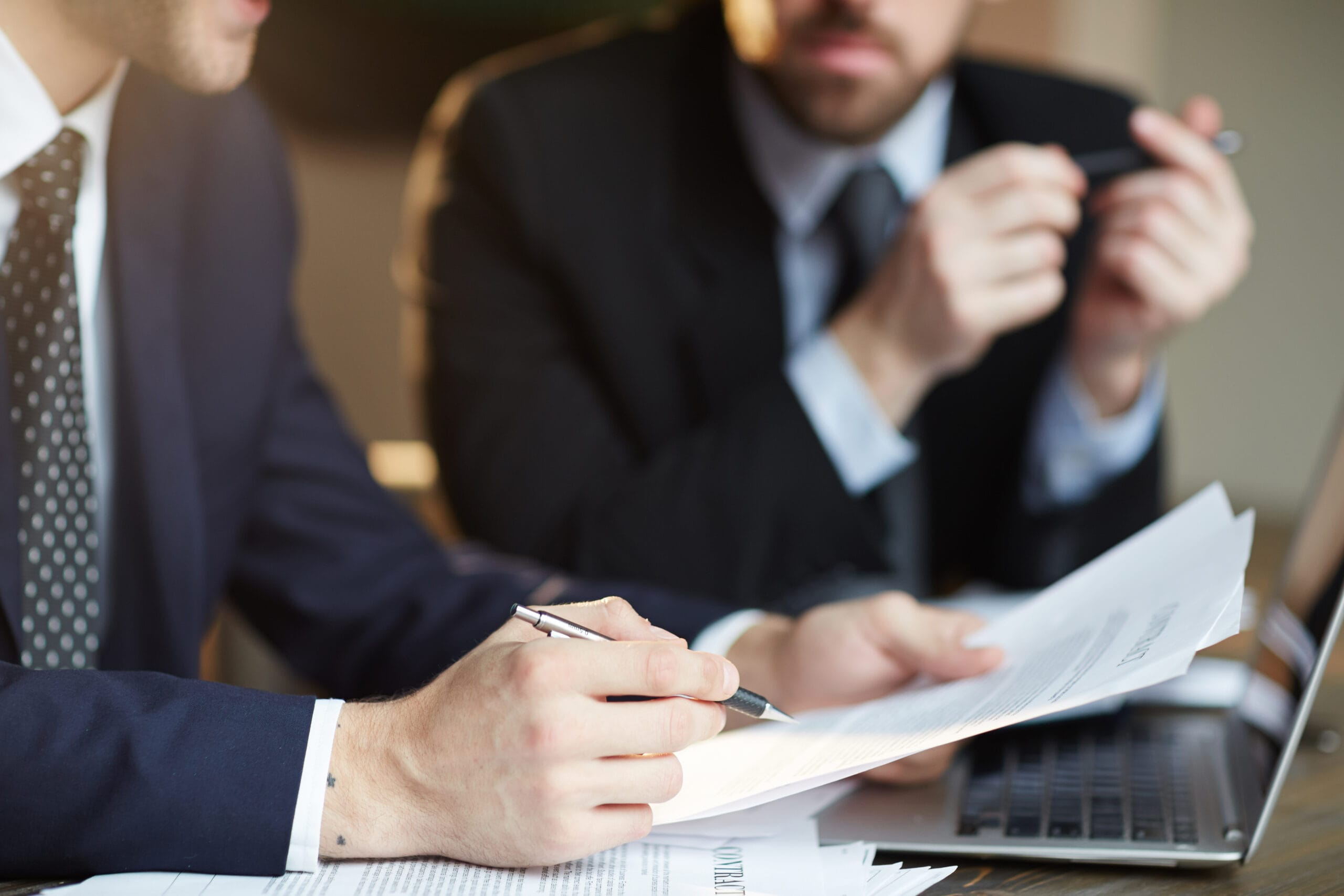 Two business people discussing documents