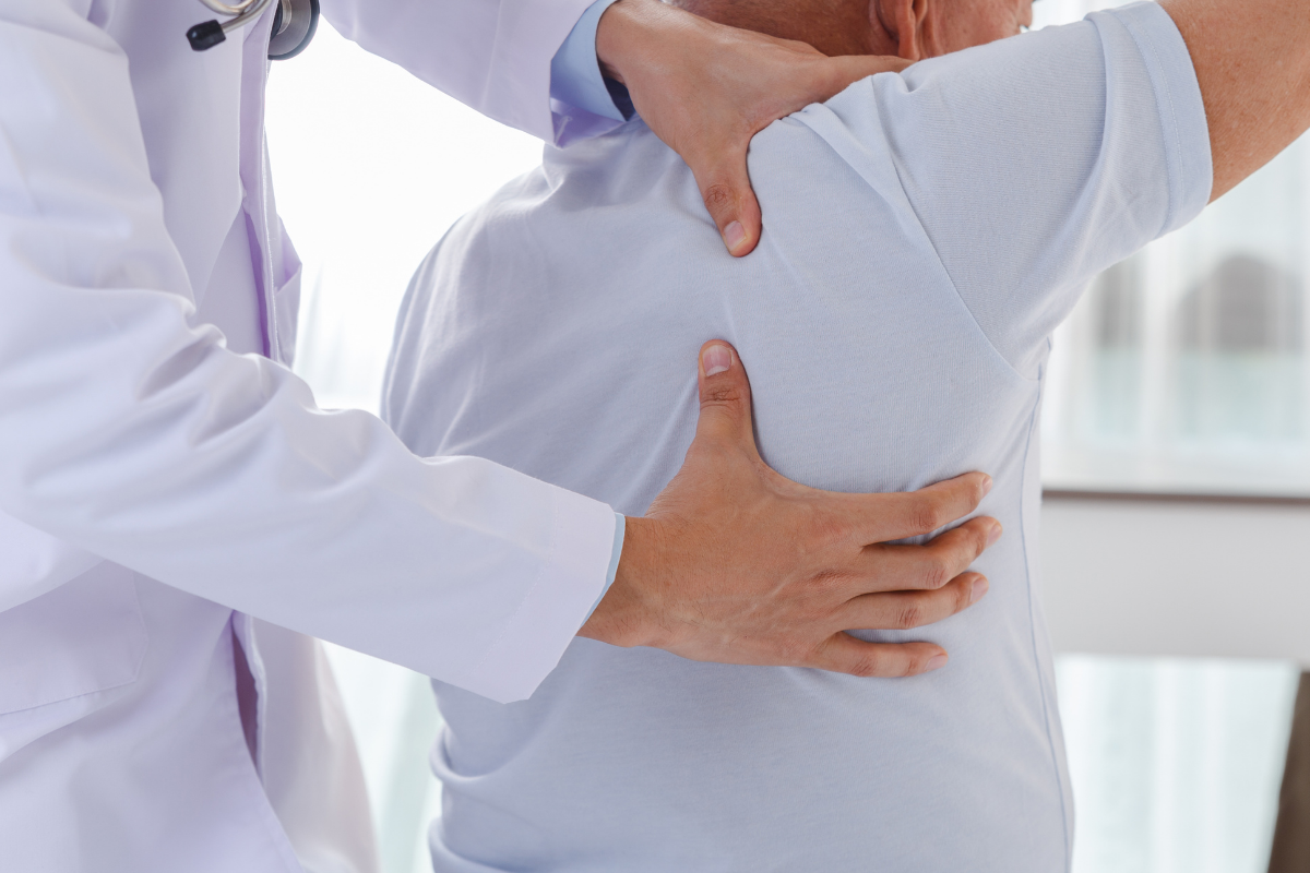 A doctor examining a person's back