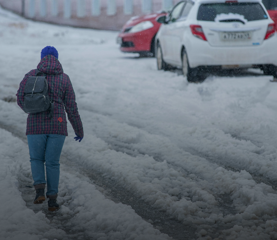 Person walking on the road in heavy snow